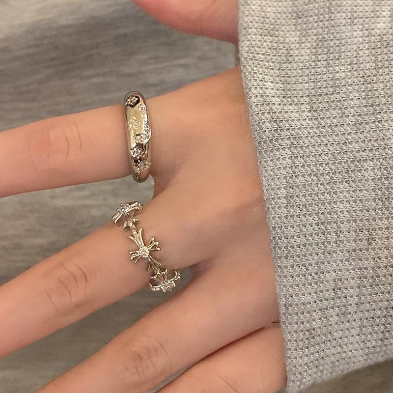 Delicate ring styled on a hand with another statement ring