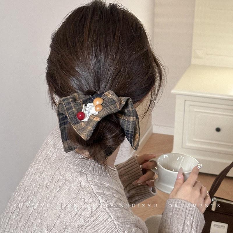 Plaid ribbon hair accessory styled with a low bun